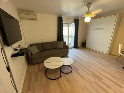 a living room with a couch and a table at 4 People Cannes Hyper Centre and Air conditioning in Cannes