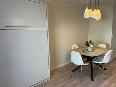 a dining room with a table and white chairs at 4 People Cannes Hyper Centre and Air conditioning in Cannes
