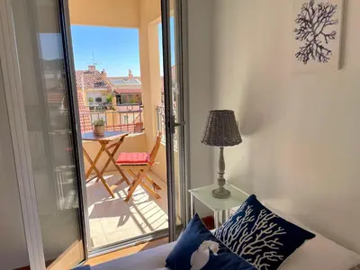 a living room with a blue couch and a table at Harbor Dockside in Cannes