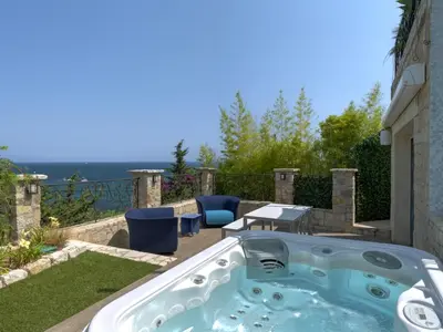 a jacuzzi tub on the patio of a house at Immogroom - Amazing Villa with sea view in Vallauris