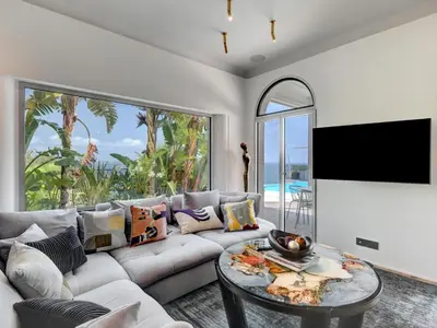 a living room with a couch and a table at Immogroom - Amazing Villa with sea view in Vallauris