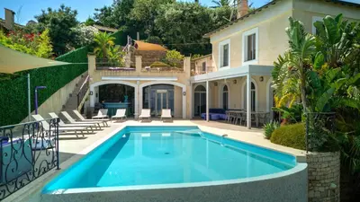 a swimming pool in front of a house at Immogroom - Amazing Villa with sea view in Vallauris