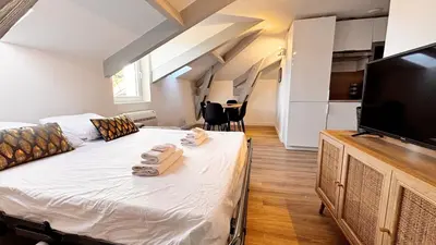 a bedroom with a bed with towels on it at Proche gare, 5min Plage du Midi, T3, 6 personnes By Palmazur Vacances in Cannes