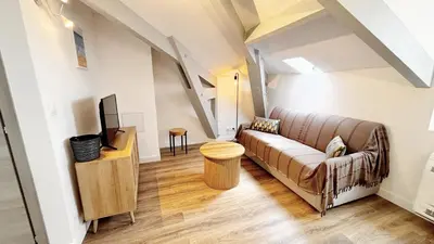 a living room with a couch and a tv at Proche gare, 5min Plage du Midi, T3, 6 personnes By Palmazur Vacances in Cannes