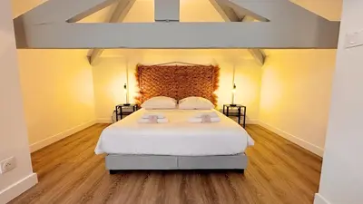 a bedroom with a large white bed with two lamps at Proche gare, 5min Plage du Midi, T3, 6 personnes By Palmazur Vacances in Cannes