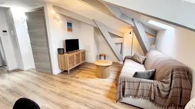 a living room with a couch and a tv at Proche gare, 5min Plage du Midi, T3, 6 personnes By Palmazur Vacances in Cannes