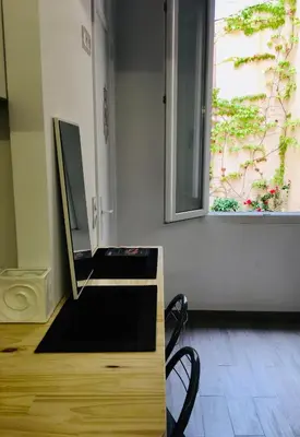a room with a vanity with a mirror and a window at Calmette in Cannes