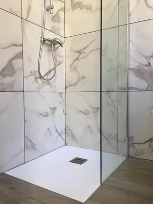 a bathroom with a shower with marble walls at Calmette in Cannes