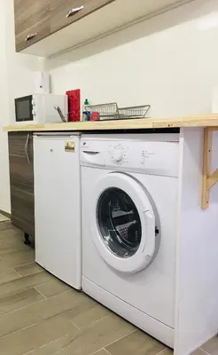 a white washing machine in a kitchen with a counter at Calmette in Cannes