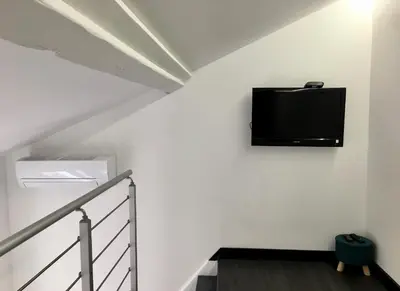 a flat screen tv hanging on a white wall at Calmette in Cannes