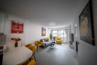 a living room with a couch and a table and chairs at Luxe 1 minute a pied du Martinez plage shopping vu Mer in Cannes
