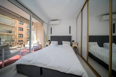 a bedroom with a large bed and a large mirror at Luxe 1 minute a pied du Martinez plage shopping vu Mer in Cannes
