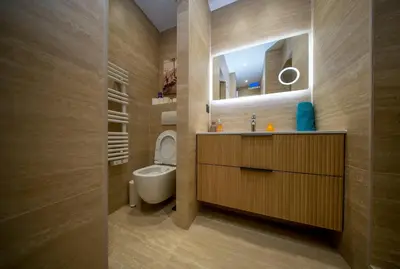 a bathroom with a sink and a toilet and a mirror at Luxe 1 minute a pied du Martinez plage shopping vu Mer in Cannes