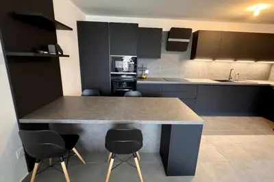 a kitchen with a counter and chairs in it at Charming 3 rooms located in Le Cannet near Cannes in Le Cannet