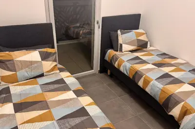 two beds sitting next to each other in a room at Charming 3 rooms located in Le Cannet near Cannes in Le Cannet