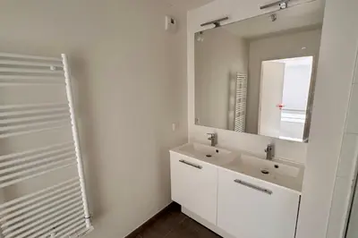 a white bathroom with a sink and a mirror at Charming 3 rooms located in Le Cannet near Cannes in Le Cannet