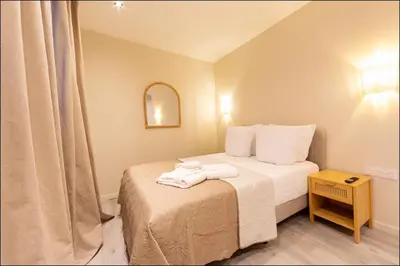 a bathroom with a toilet and a glass shower at Hotel Villa Botanica in Cannes