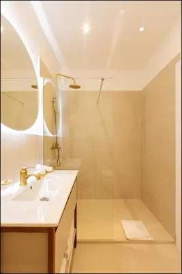 a bed with a white pillow and a lamp at Hotel Villa Botanica in Cannes