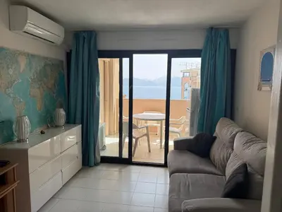 a living room with a couch and a view of the ocean at Pierre Vacances VUE MER 748 in Cannes
