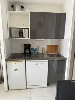 a small kitchen with a sink and a microwave at Pierre Vacances VUE MER 748 in Cannes