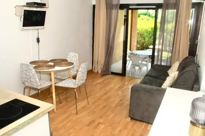 a living room with a table and chairs and a couch at T2 Mer et Piscine Cannes 4 pers in Cannes
