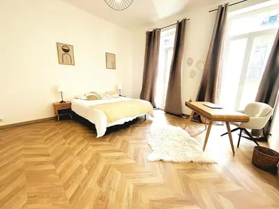 a bedroom with a bed and a wooden floor at Cannes Banane in Cannes