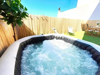 a hot tub in a backyard with a fence at Cannes Banane in Cannes