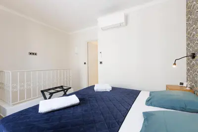 a bedroom with a blue bed with towels on it at Duplex Charmant et Central Cannes Forville in Cannes