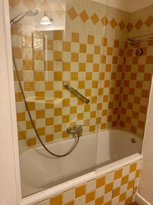 a bathroom with a bath tub with a shower at Renoir 252 - Appartement rez-de-jardin type F2 - Petite vue mer in Cannes
