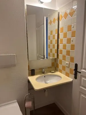 a bathroom with a sink and a mirror at Renoir 252 - Appartement rez-de-jardin type F2 - Petite vue mer in Cannes