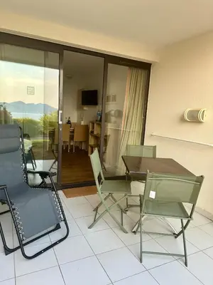 a room with a table and chairs and a dining room at Renoir 252 - Appartement rez-de-jardin type F2 - Petite vue mer in Cannes