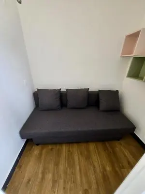 a couch in the corner of a room at Ingres 158 - F3 vue mer Villa Francia in Cannes