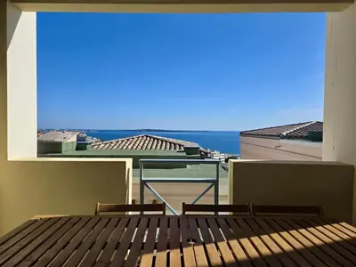 a balcony with two benches and a view of the ocean at Ingres 158 - F3 vue mer Villa Francia in Cannes