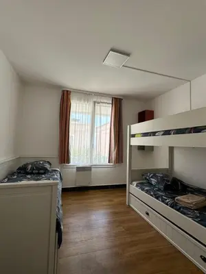 a room with two bunk beds and a window at Ingres 158 - F3 vue mer Villa Francia in Cannes