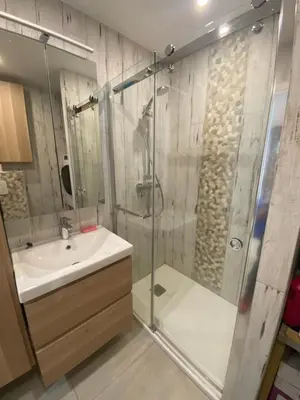 a bathroom with a glass shower and a sink at Le Baronne- Charmant studio climatisé au calme proche Plage et Palais des Festivals in Cannes