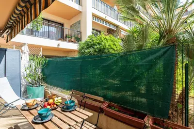 a patio with a table with fruit on it at Le Baronne- Charmant studio climatisé au calme proche Plage et Palais des Festivals in Cannes
