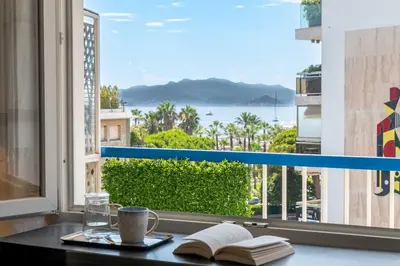 a desk with a book and a book at 2-Br Apartment with Terrace & Sea View Palm Beach Cannes in Cannes