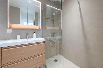 a bathroom with a sink and a shower at 2-Br Apartment with Terrace & Sea View Palm Beach Cannes in Cannes