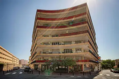 a tall building with a tree in front of it at FRGK Stanislas Apartment Terrace, Central Cannes AC & ULTRA FAST Wi-Fi in Cannes