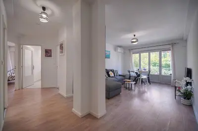 a living room with a couch and a table at FRGK Stanislas Apartment Terrace, Central Cannes AC & ULTRA FAST Wi-Fi in Cannes