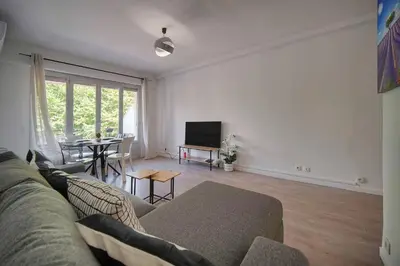 a living room with a couch and a table at FRGK Stanislas Apartment Terrace, Central Cannes AC & ULTRA FAST Wi-Fi in Cannes