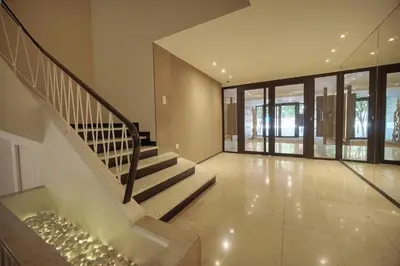 a staircase in a house with glass doors and windows at FRGK Stanislas Apartment Terrace, Central Cannes AC & ULTRA FAST Wi-Fi in Cannes
