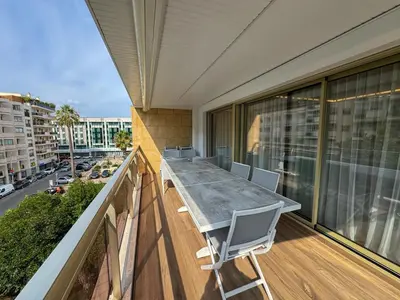 a balcony with a table and chairs on a building at LUXURY EQUINOX 3 Bedrooms in Cannes