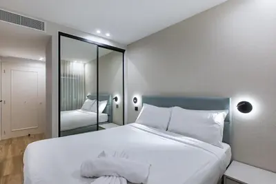 a balcony with chairs and a table and a balcony with a building at LUXURY EQUINOX 3 Bedrooms in Cannes
