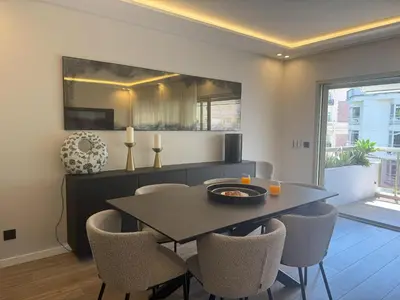 a balcony with a table and a view of a building at LUXURY EQUINOX 3 Bedrooms in Cannes