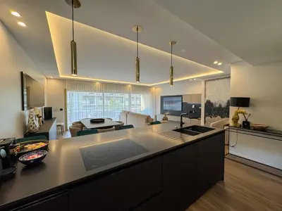 a living room with two chairs and a television at LUXURY EQUINOX 3 Bedrooms in Cannes