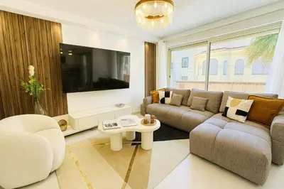 a living room with a couch and a table at Newly Renovated 2BR Modern in Cannes
