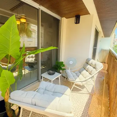 a patio with two white chairs and a table at Newly Renovated 2BR Modern in Cannes