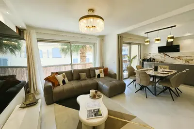 a living room with a couch and a table at Newly Renovated 2BR Modern in Cannes