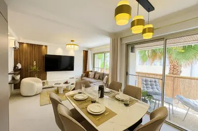 a living room with a table and chairs at Newly Renovated 2BR Modern in Cannes